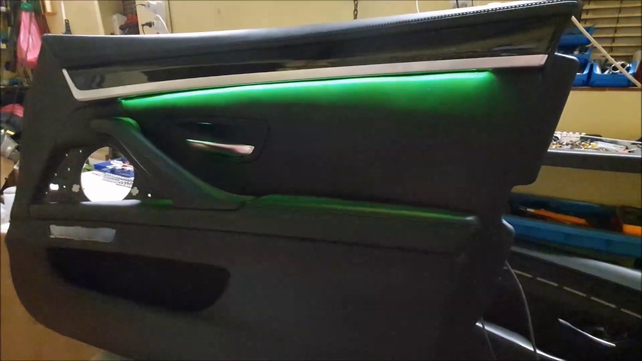 Door panel removed, tapping power from a dome/courtesy light with soldered connection and heat shrink tubing.