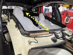 Technician removing overhead console